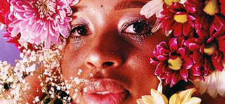 Close up female face with flowers all around head